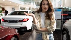 young woman can not decide on the purchase of a new car