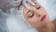 Woman receiving botox injection at clinic