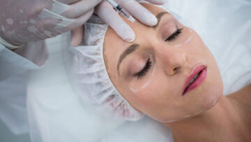 Woman receiving botox injection at clinic
